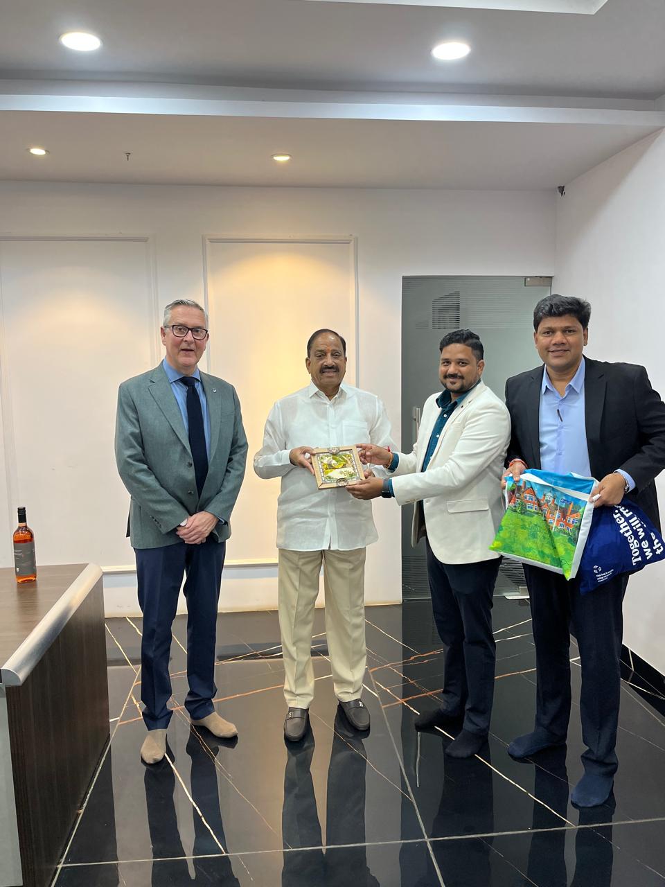 Harper Adams University and UVG Group with the Agriculture Minister of Telangana, holding a framed gift and a university bag